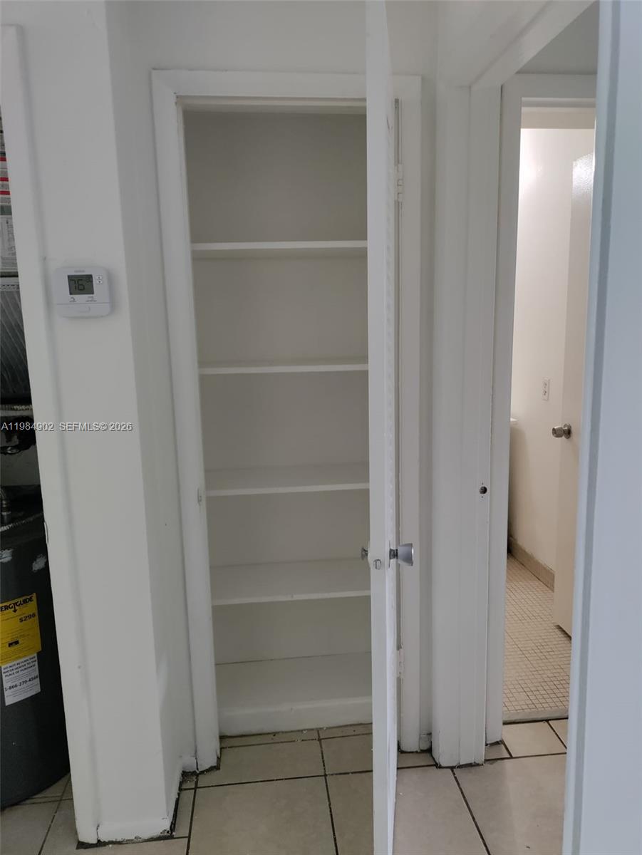 7340 Southwest 82nd Street, Unit C205 Miami, FL 33143 - Photo 18 of 34 a view of walk in closet with empty racks