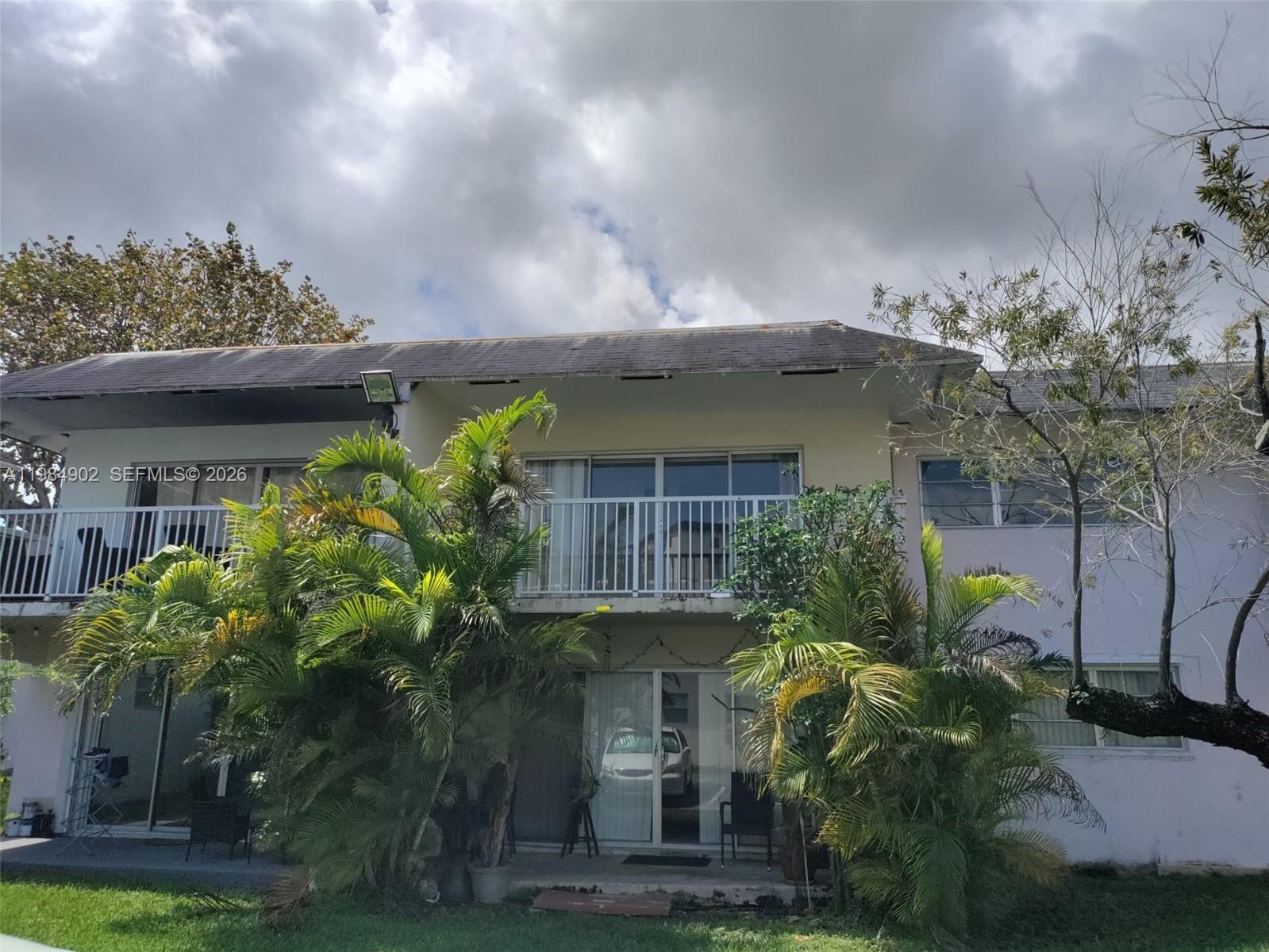 7340 Southwest 82nd Street, Unit C205 Miami, FL 33143 - Photo 34 of 34 a front view of a house with plants