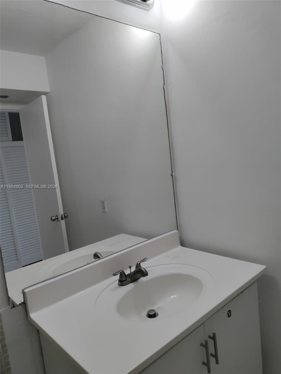 7340 Southwest 82nd Street, Unit C205 Miami, FL 33143 - Photo 4 of 34 a bathroom with a sink and a mirror