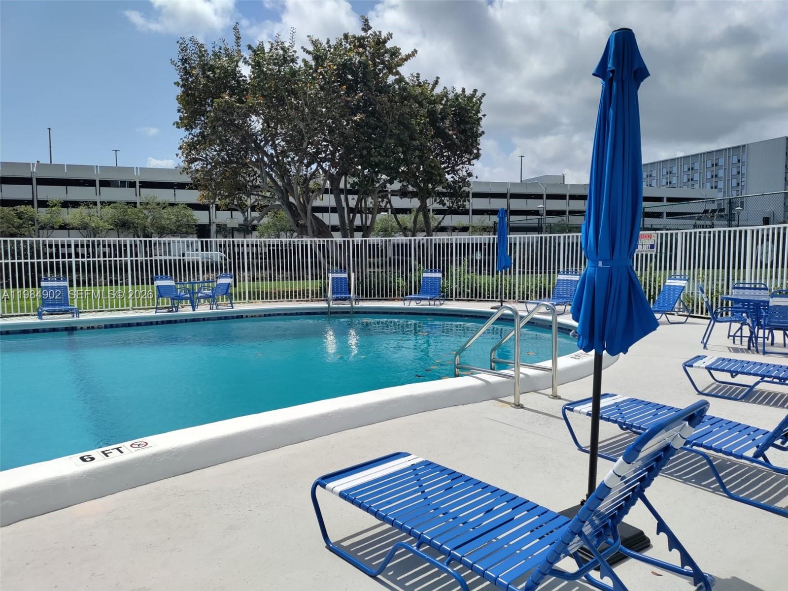 7340 Southwest 82nd Street, Unit C205 Miami, FL 33143 - Photo 6 of 34 a swimming pool with outdoor seating and yard