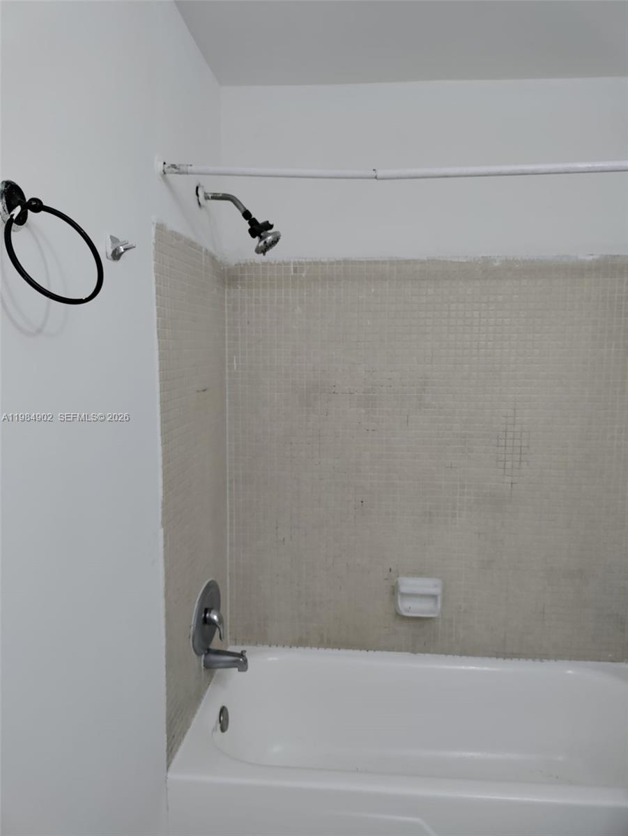 7340 Southwest 82nd Street, Unit C205 Miami, FL 33143 - Photo 7 of 34 a bathroom with a bathtub