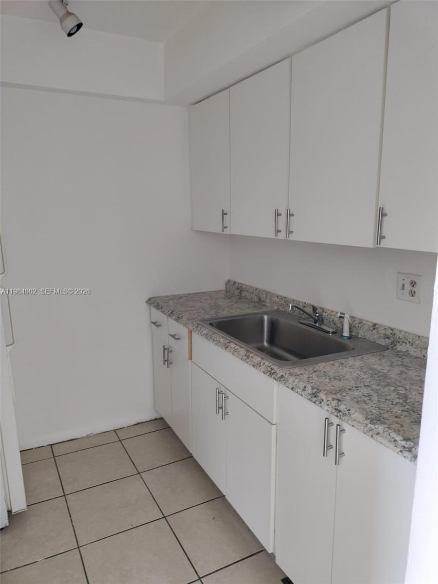 7340 Southwest 82nd Street, Unit C205 Miami, FL 33143 - Photo 10 of 34 a kitchen with white cabinets