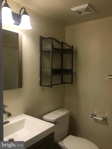 a bathroom with a sink toilet and vanity