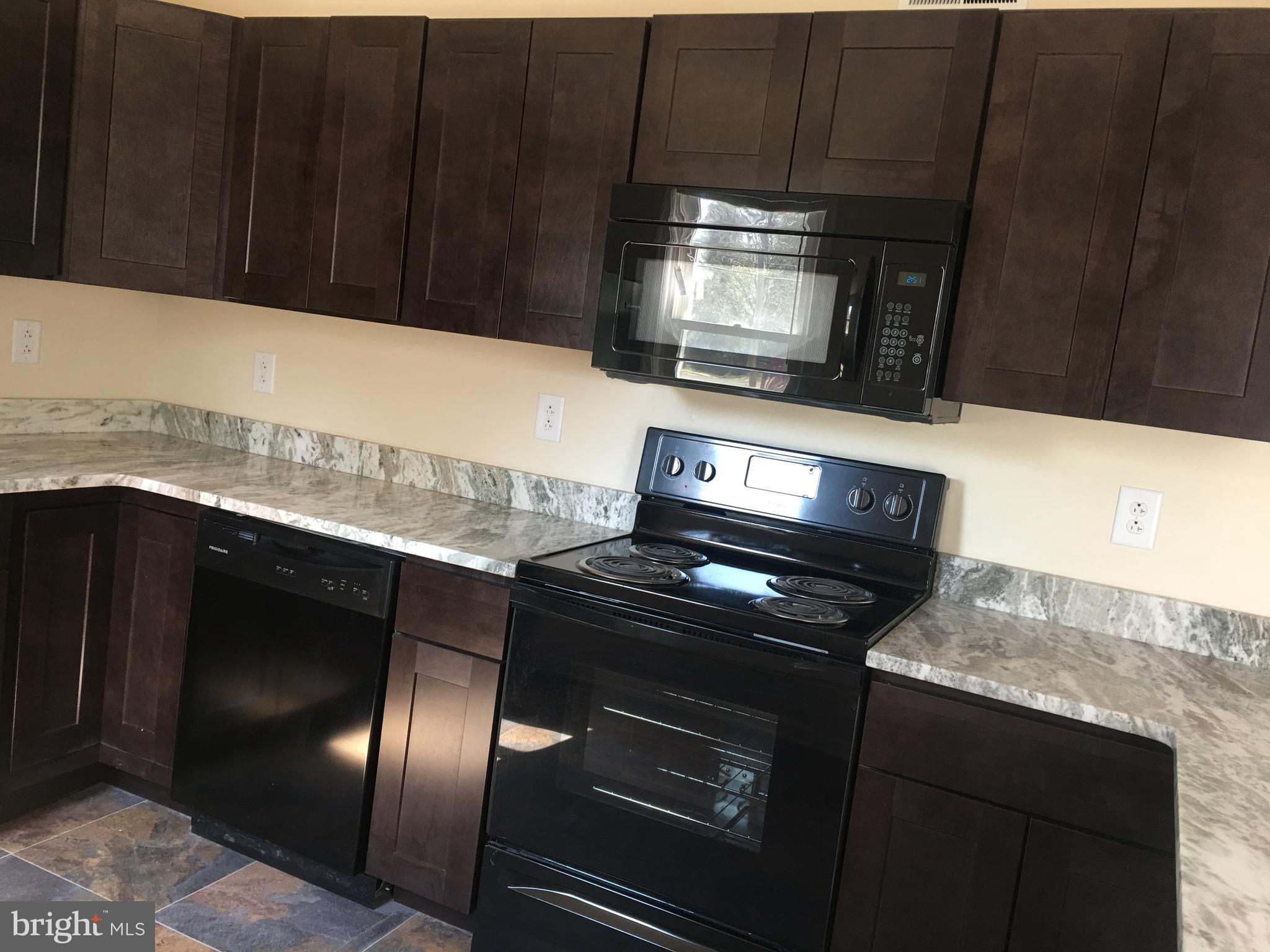1 Pennsylvania Road, Unit 11 Glassboro, NJ 08028 - Photo 2 of 17 a kitchen with granite countertop stainless steel appliances and cabinets