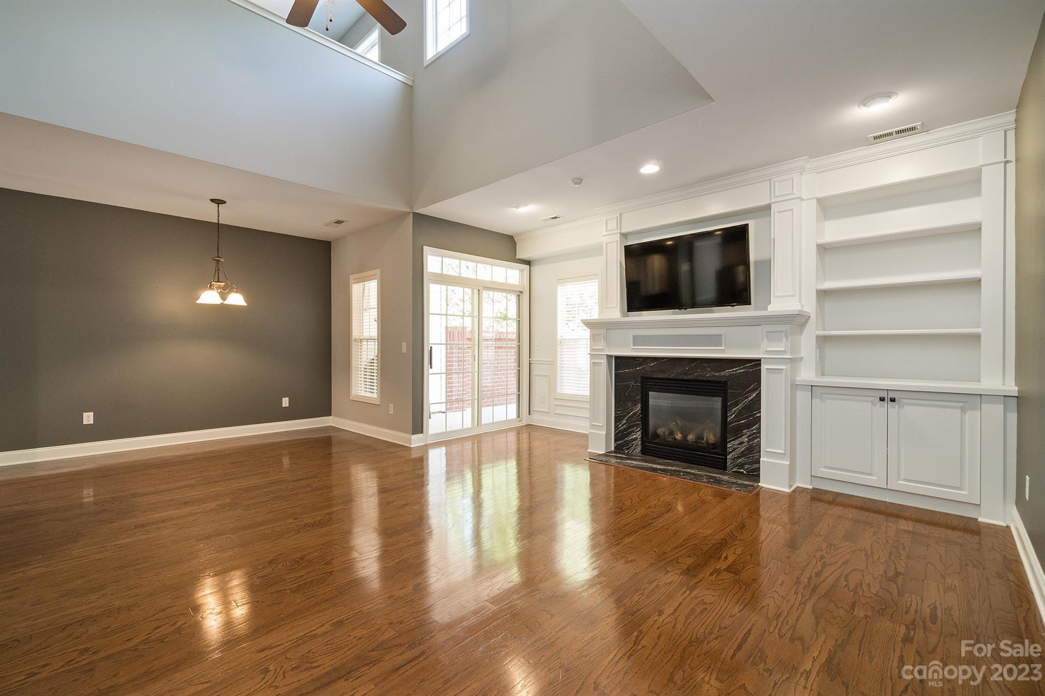 20232 Middletown Road Cornelius, NC 28031 - Photo 14 of 40 a view of an empty room with a fireplace and a window