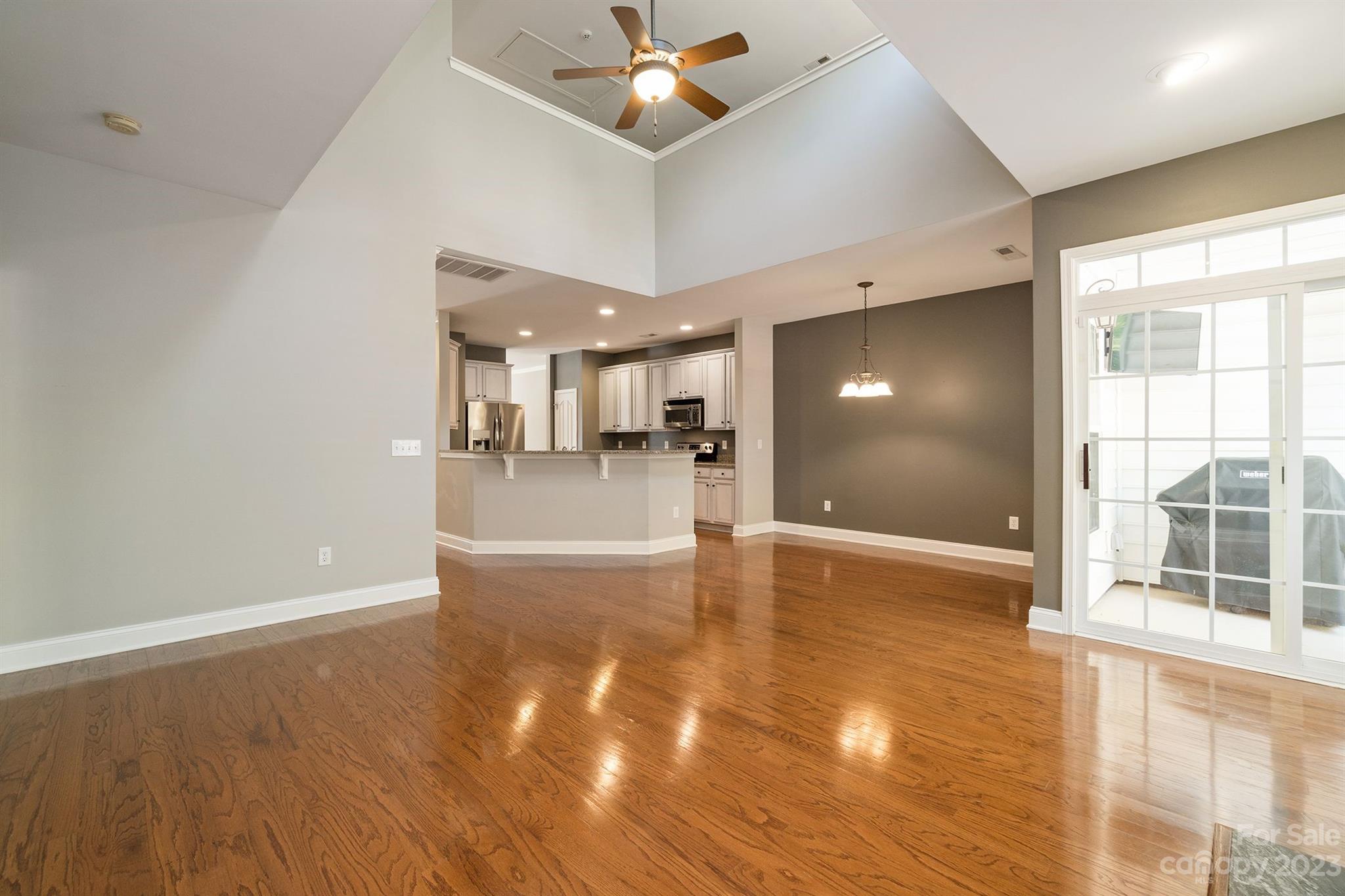 20232 Middletown Road Cornelius, NC 28031 - Photo 15 of 40 a view of a livingroom with wooden floor and a kitchen