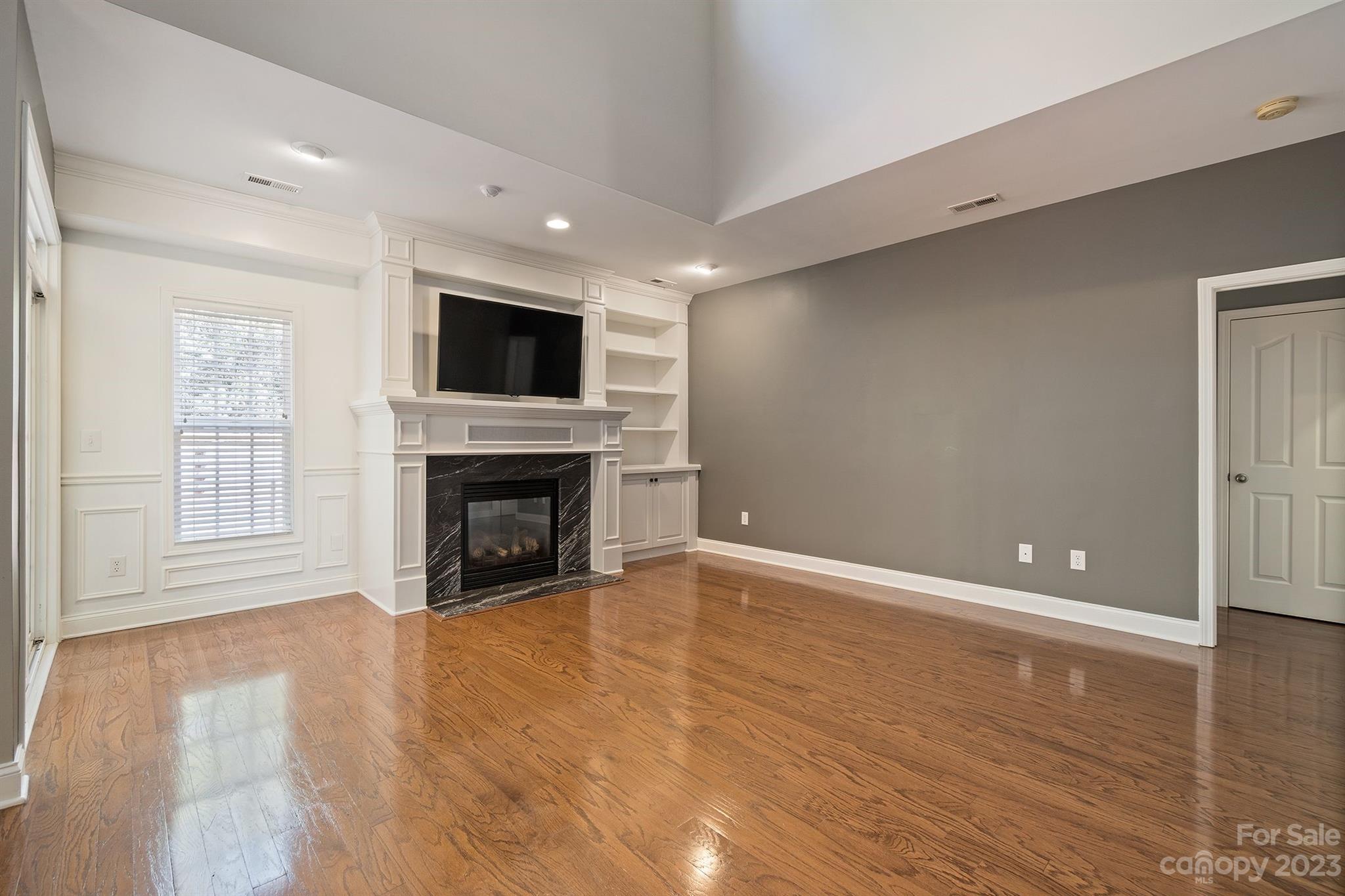 20232 Middletown Road Cornelius, NC 28031 - Photo 16 of 40 a view of a livingroom with a fireplace a fireplace and wooden floor