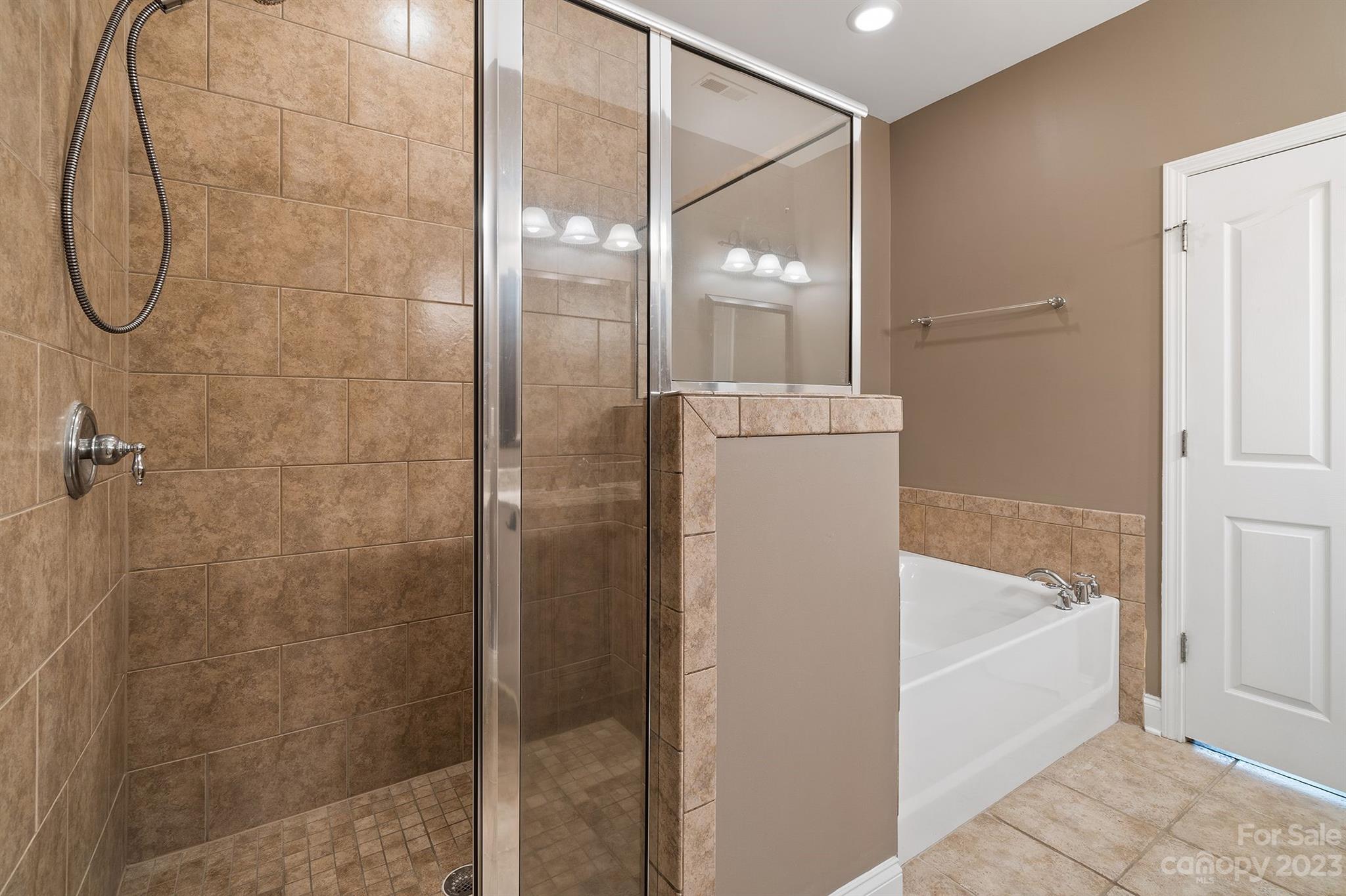 20232 Middletown Road Cornelius, NC 28031 - Photo 20 of 40 a bathroom with a bathtub and shower