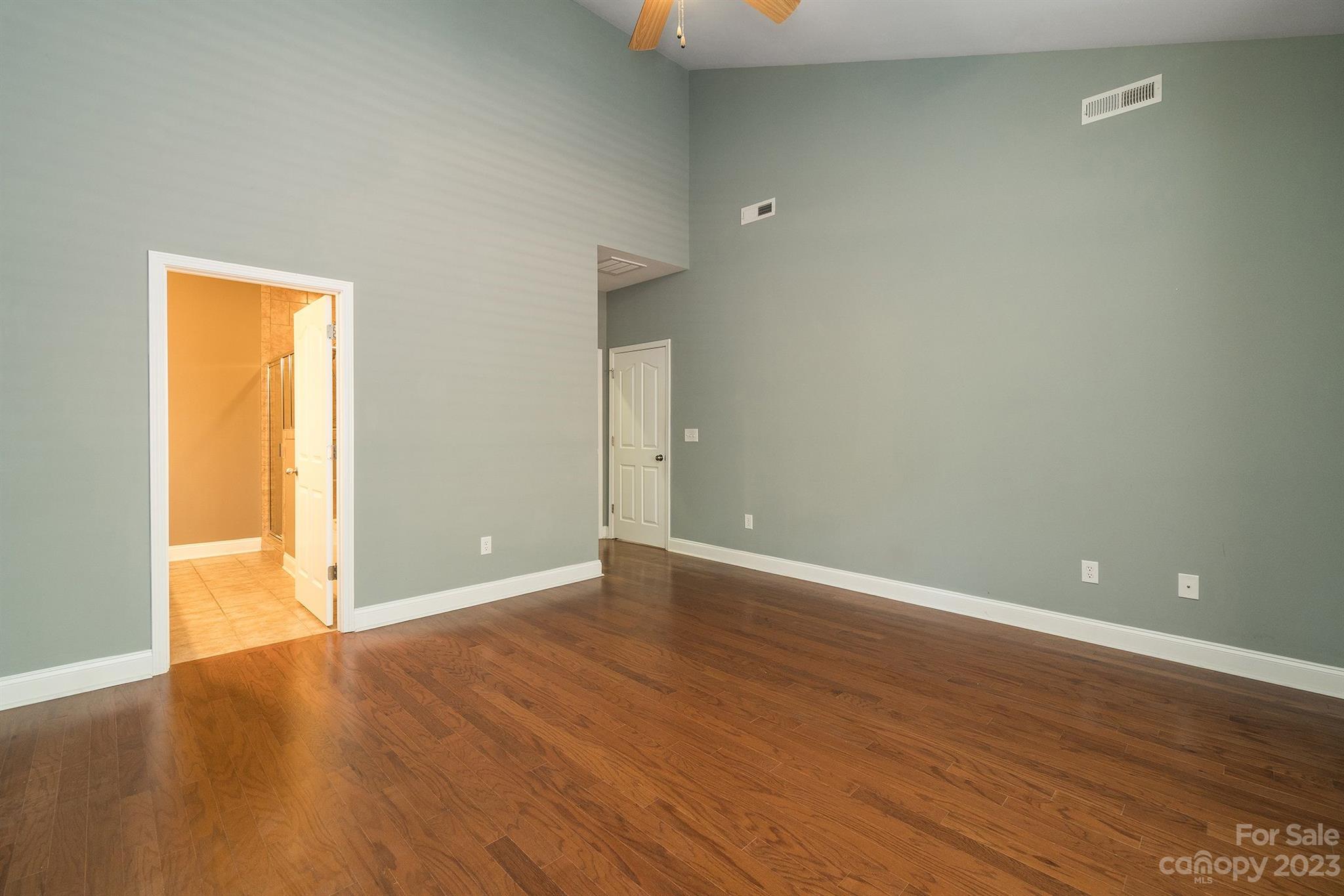 20232 Middletown Road Cornelius, NC 28031 - Photo 24 of 40 a view of an empty room with wooden floor and a window