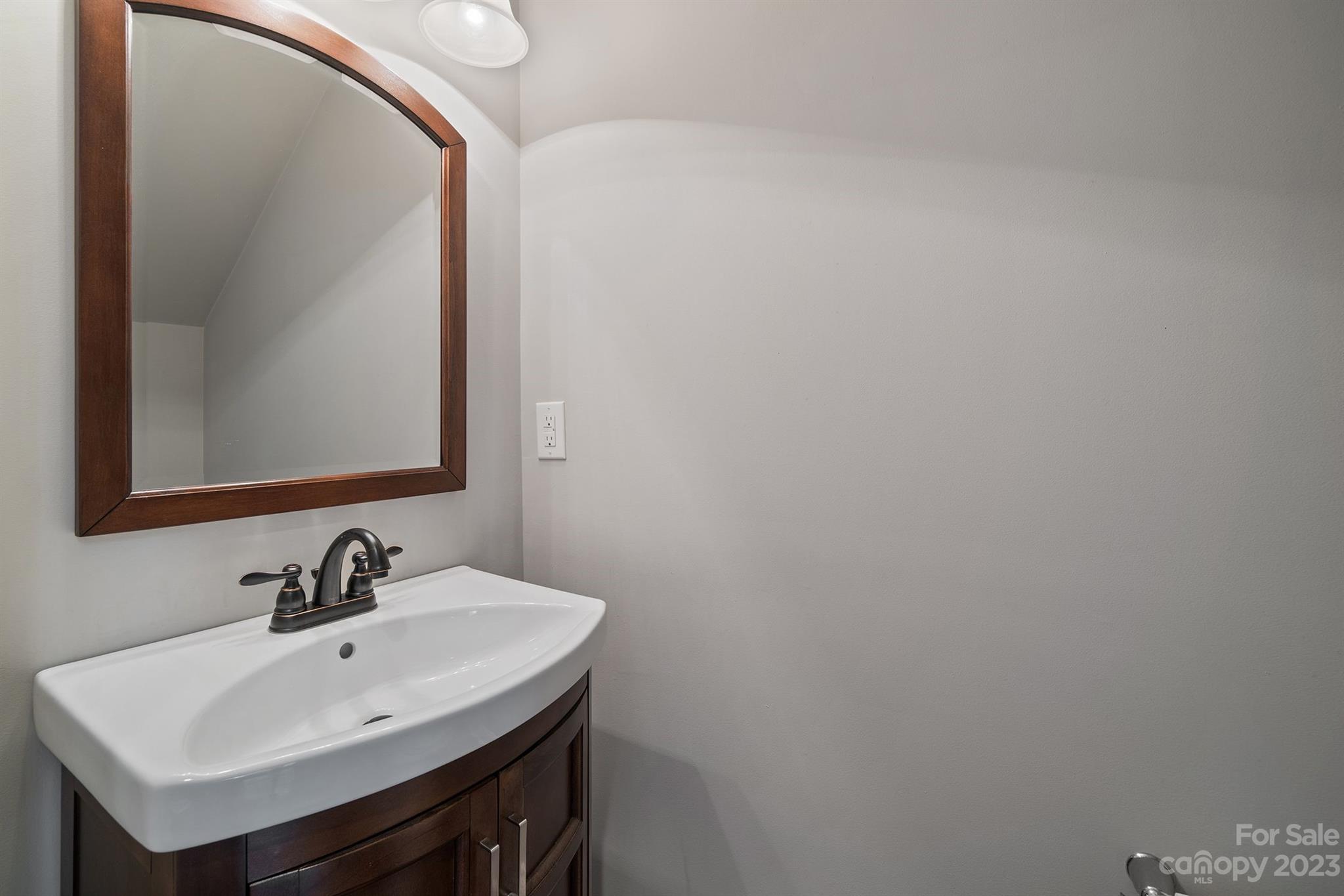 20232 Middletown Road Cornelius, NC 28031 - Photo 28 of 40 a bathroom with a sink and a mirror