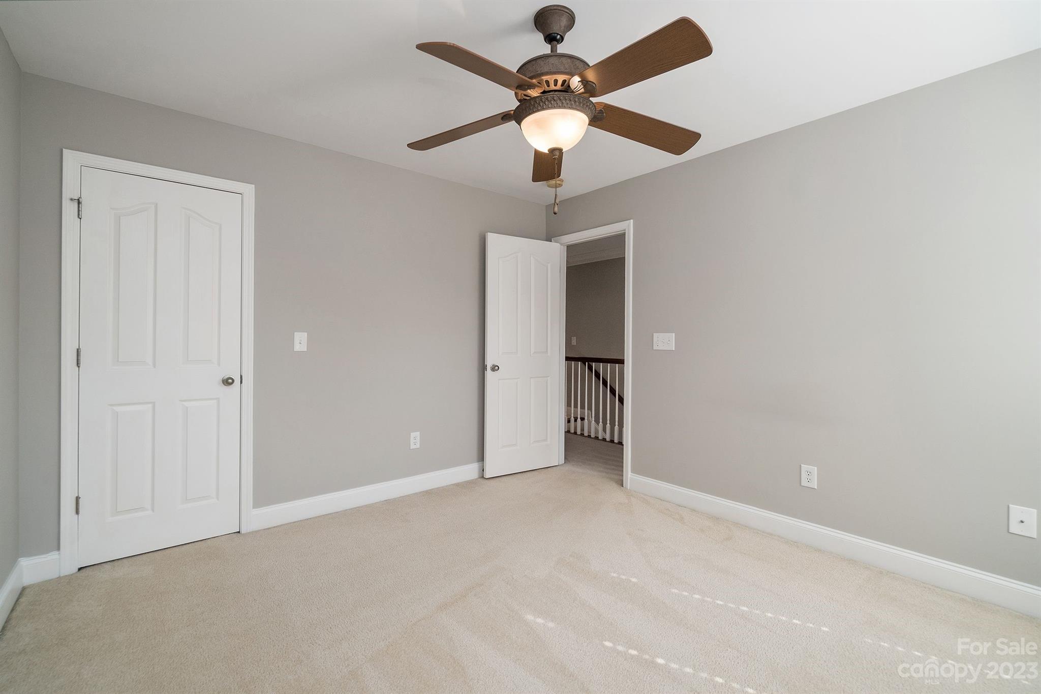 20232 Middletown Road Cornelius, NC 28031 - Photo 35 of 40 an empty room with a ceiling fan and a window