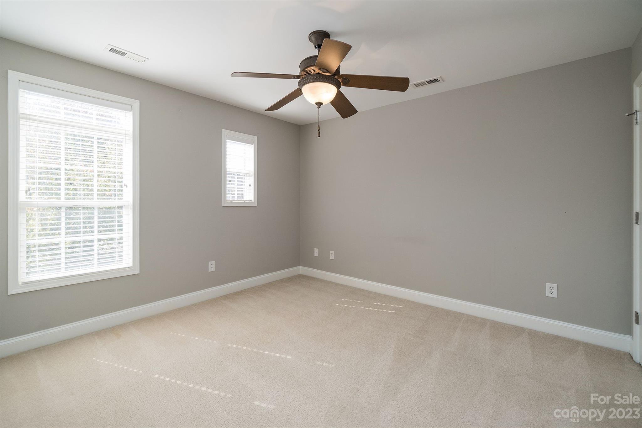20232 Middletown Road Cornelius, NC 28031 - Photo 36 of 40 an empty room with a window and a fan