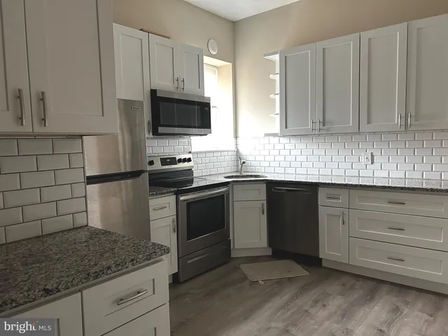 a kitchen with a sink and stainless steel appliances