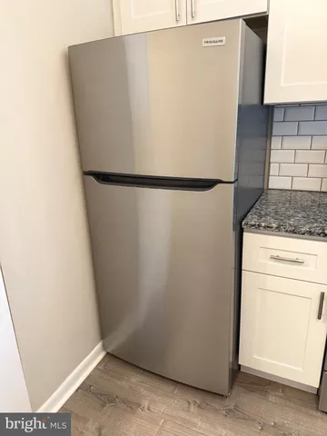 a white refrigerator freezer sitting in a kitchen