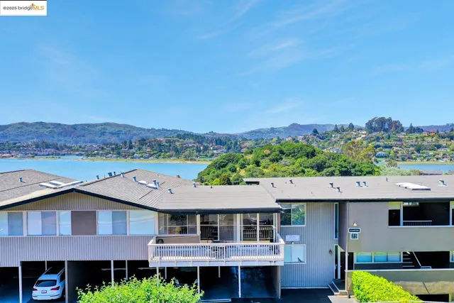 an aerial view of a houses with a lake view