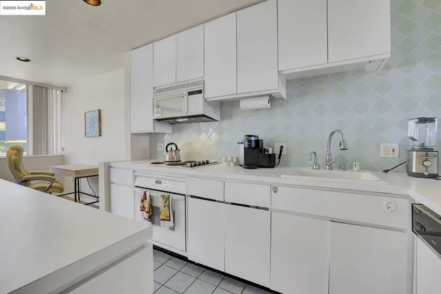 a kitchen with cabinets appliances a sink and a counter top