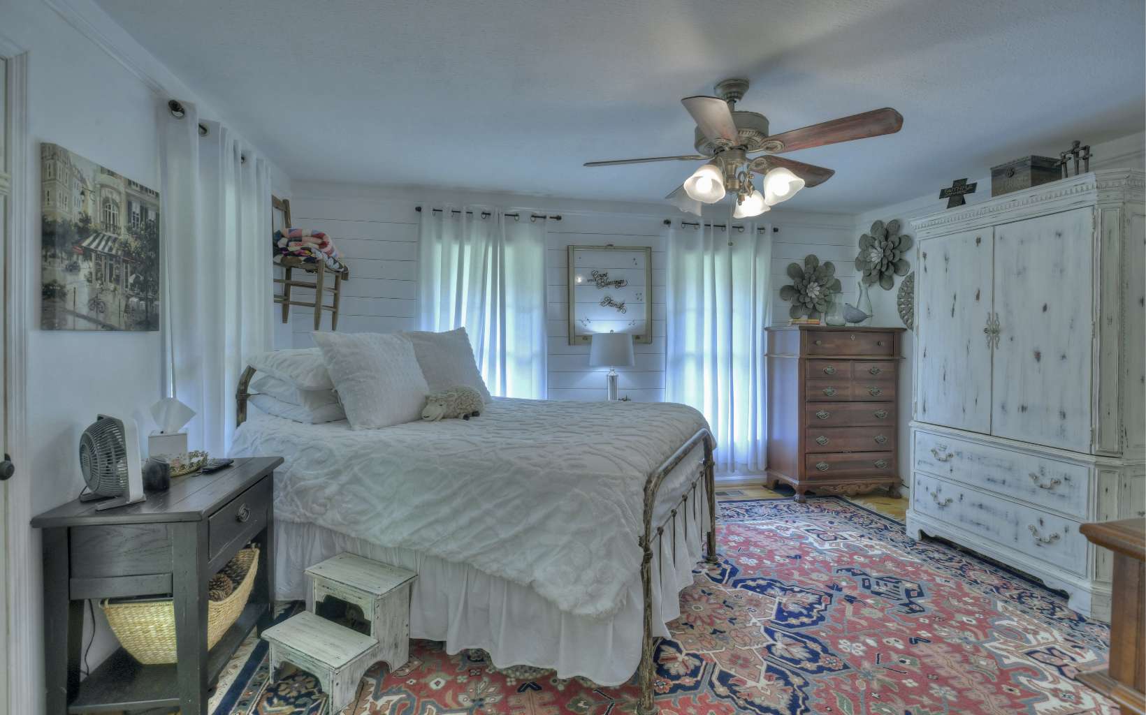 920 Tennis Court Road Blue Ridge, GA 30513 - Photo 12 of 56 a spacious bedroom with a bed and a chandelier