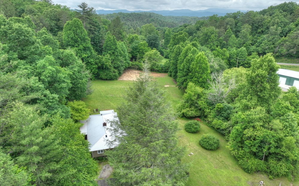 920 Tennis Court Road Blue Ridge, GA 30513 - Photo 2 of 56 a backyard of a house with a yard and outdoor seating