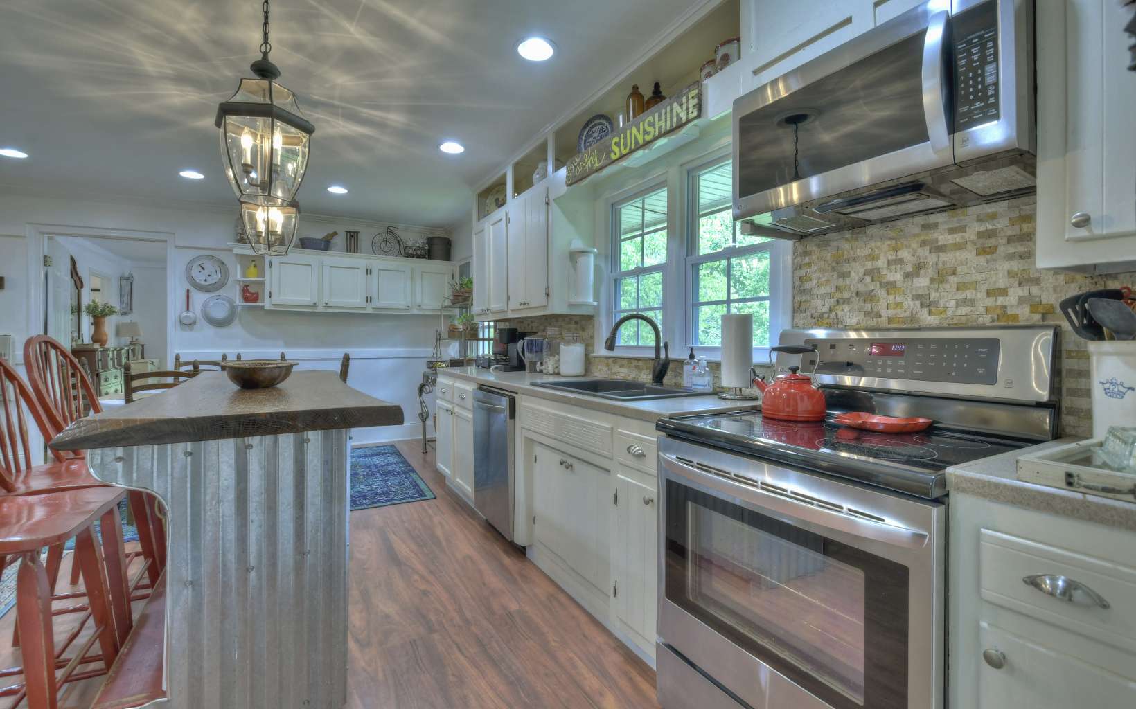 920 Tennis Court Road Blue Ridge, GA 30513 - Photo 5 of 56 a kitchen that has a lot of cabinets in it and wooden floors