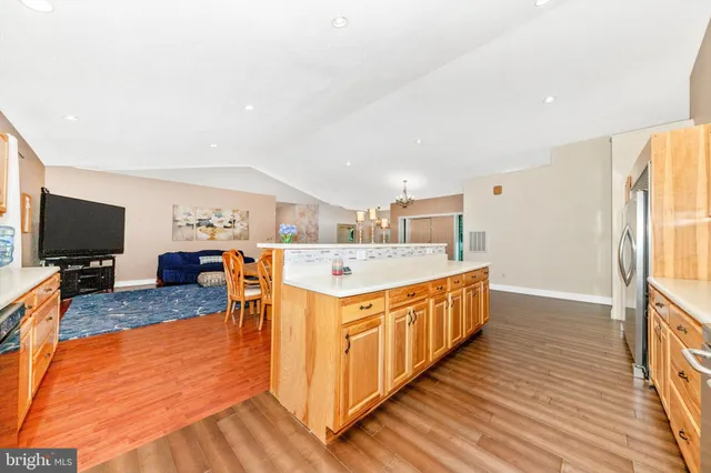 a kitchen with stainless steel appliances granite countertop a stove a sink and a refrigerator