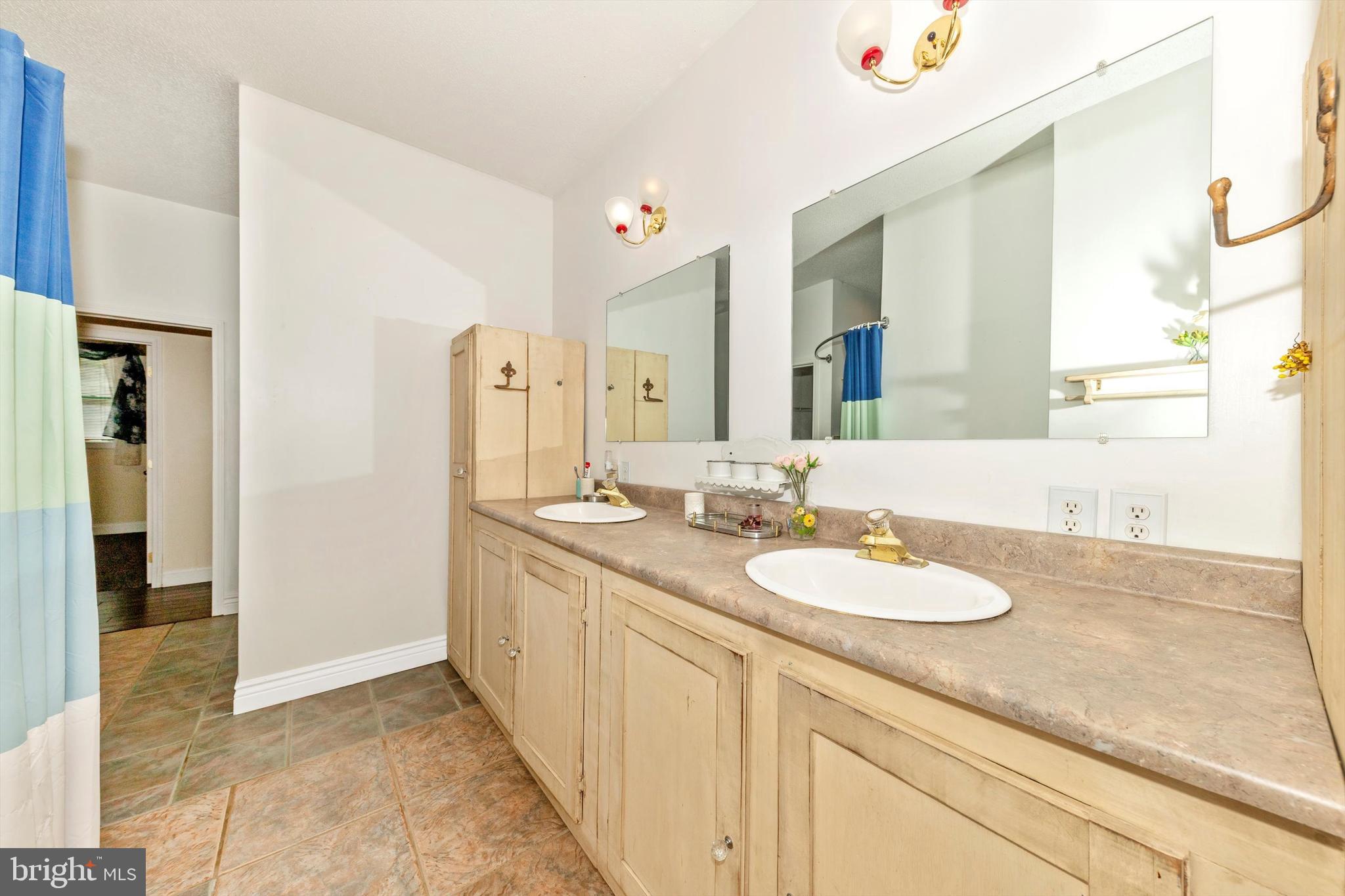 13450 Millstone Circle Hancock, MD 21750 - Photo 18 of 61 a spacious bathroom with a granite countertop sink and a mirror