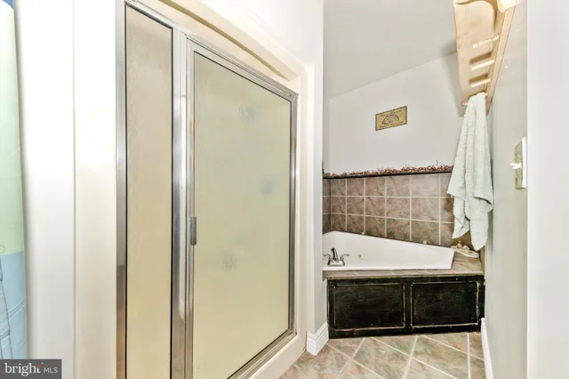 a view of a bedroom with baby bed and toys