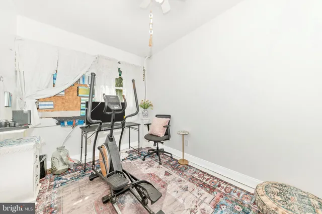 a bathroom with a granite countertop sink a toilet and a shower curtain