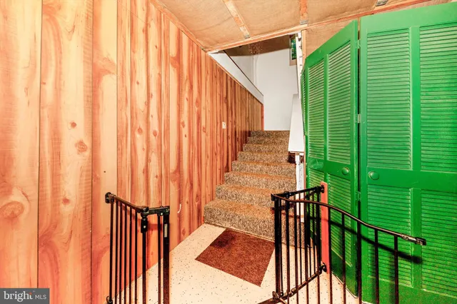 a bedroom with a bed and large windows