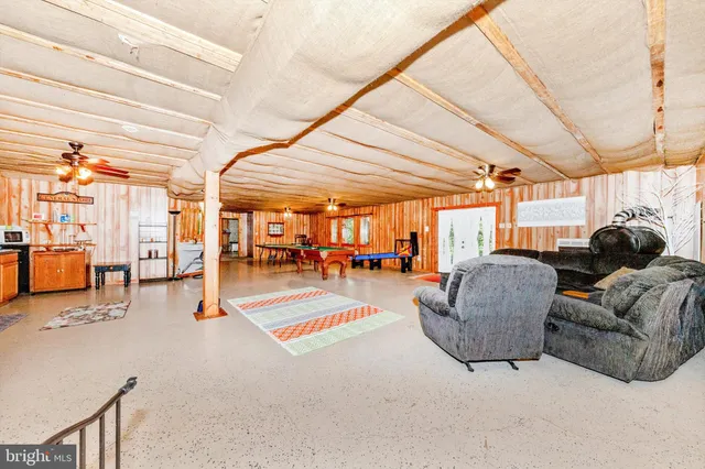 a view of a room with furniture and a large window