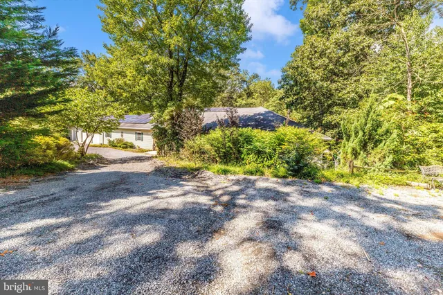 a view of a patio with table and chairs with wooden floor and fence