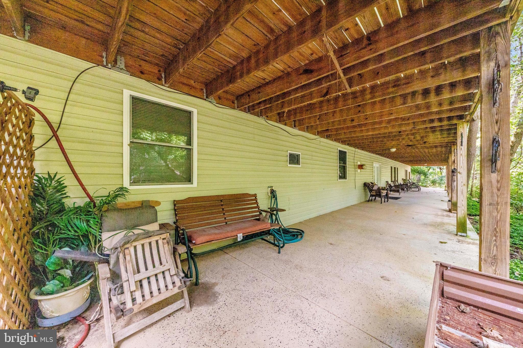13450 Millstone Circle Hancock, MD 21750 - Photo 50 of 61 a view of a patio with table and chairs with wooden floor and fence