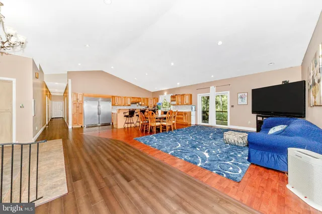 a living room with furniture rug and wooden floor