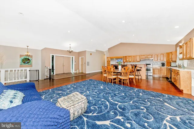 a dining room with furniture and wooden floor