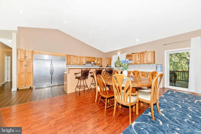 a view of a kitchen with wooden floor and furniture