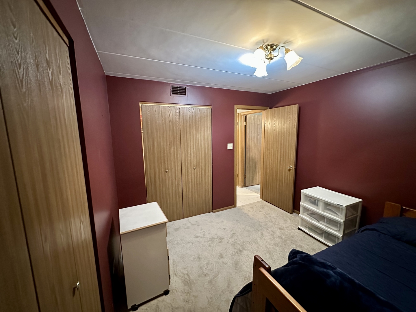 10930 Central Avenue, Unit 1B Chicago Ridge, IL 60415 - Photo 16 of 22 a bedroom with a bed and a chandelier