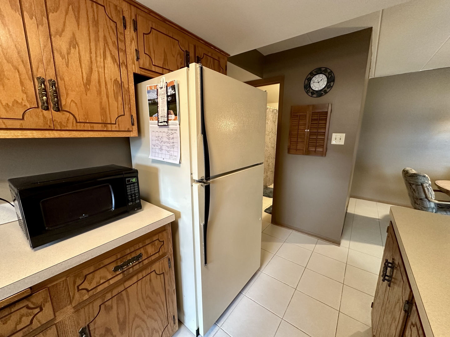 10930 Central Avenue, Unit 1B Chicago Ridge, IL 60415 - Photo 10 of 22 a white refrigerator freezer and a stove sitting inside of a kitchen