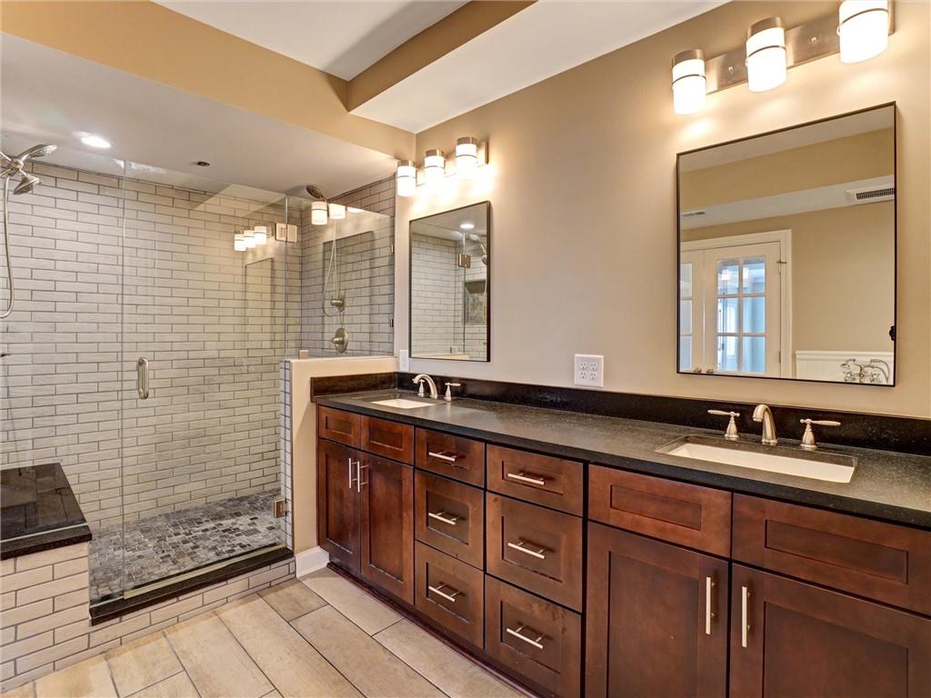 3435 Kingsboro Road Northeast, Unit 1601 Atlanta, GA 30326 - Photo 20 of 54 a bathroom with a double vanity sink and a mirror