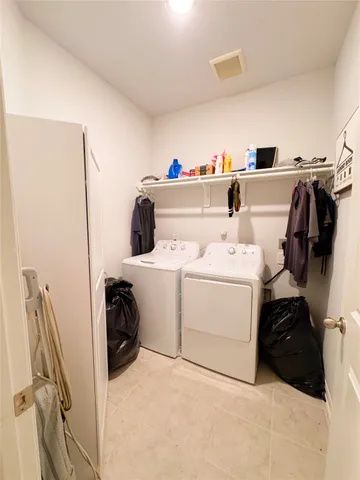 a hallway with a couch and a flat screen tv