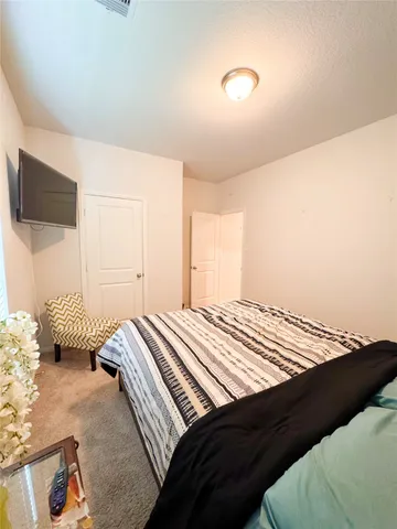 a view of a dining room with furniture and a flat screen tv