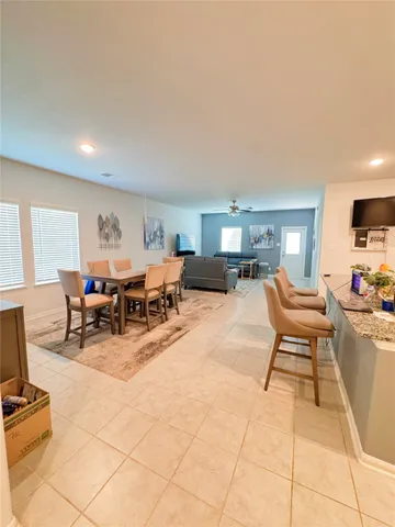 a kitchen with stainless steel appliances kitchen island granite countertop a refrigerator and a stove top oven