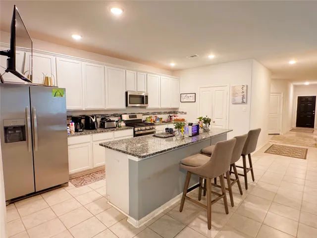 a bedroom with a bed and a chair