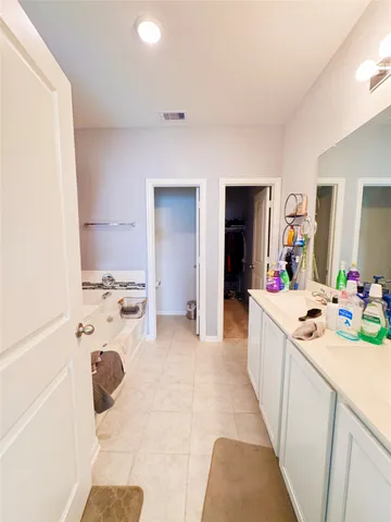 a view of walk in closet with clothes