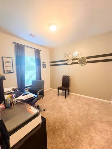 a view of workspace with wooden floor and lounge chair