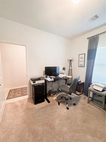 a view of a workspace with furniture