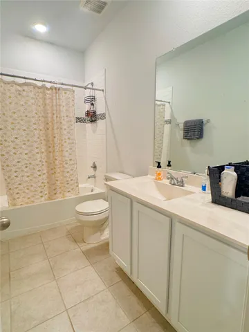 a bathroom with a sink vanity and a mirror