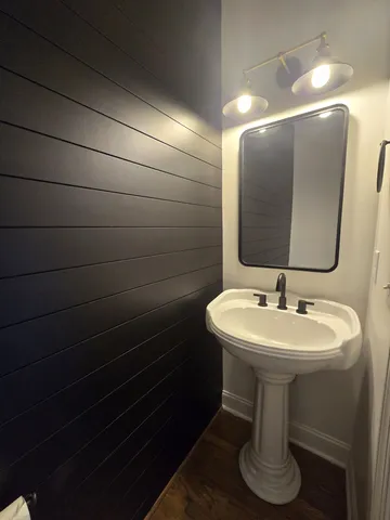 a bathroom with a sink toilet and mirror