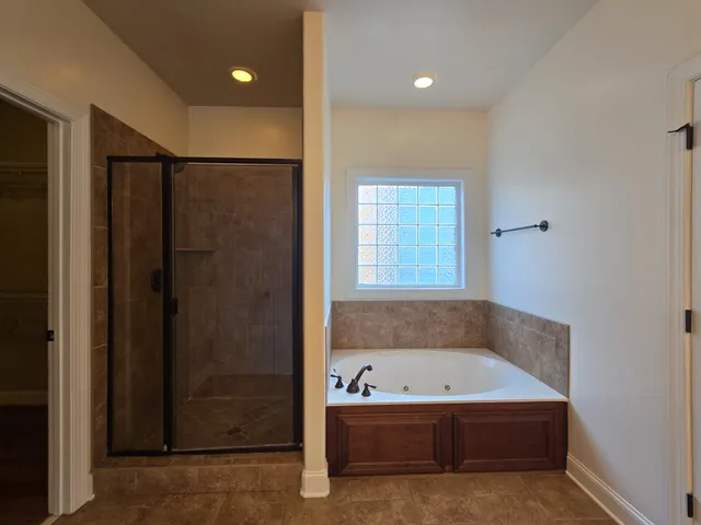 a bathroom with a bathtub and a shower