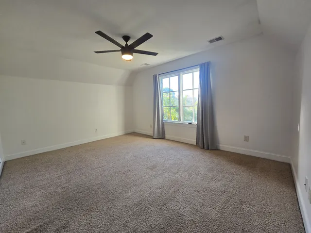 a view of a livingroom with a ceiling fan and window