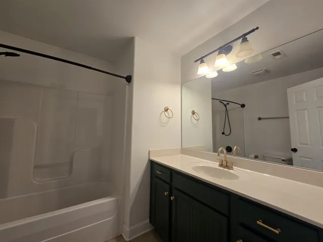 a bathroom with a double vanity sink a toilet and a mirror