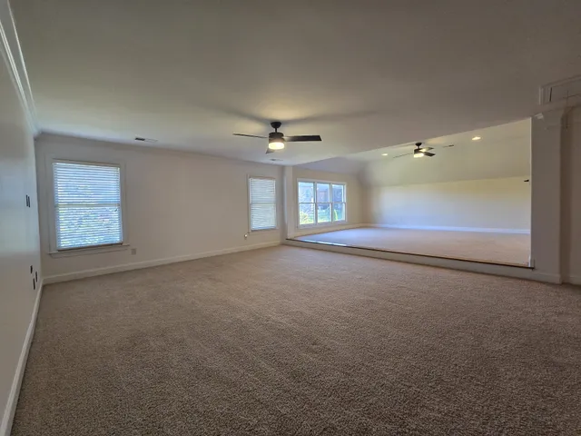 an empty room with a empty space and windows